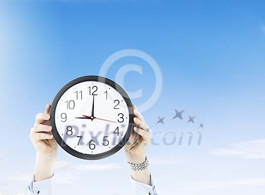 Male hands holding a clock Male hands holding a clock