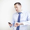 Businessman dialing a number on his phone