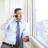 Man by the window, talking to a phone