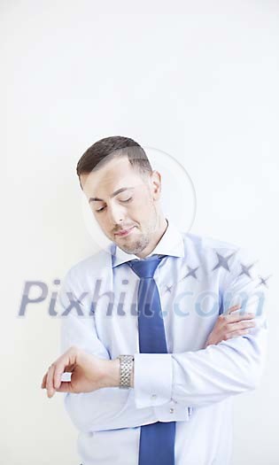 Bored looking man looking at his watch Bored looking man looking at his watch