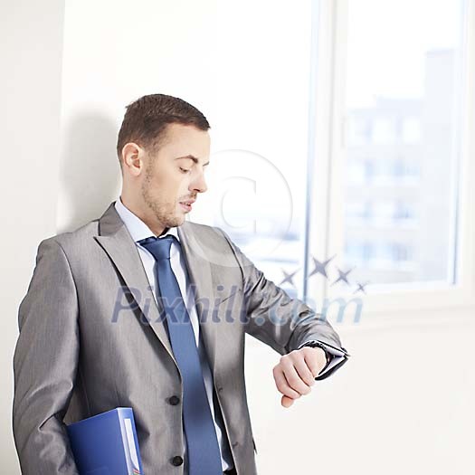 Businessman looking at his watch Businessman looking at his watch