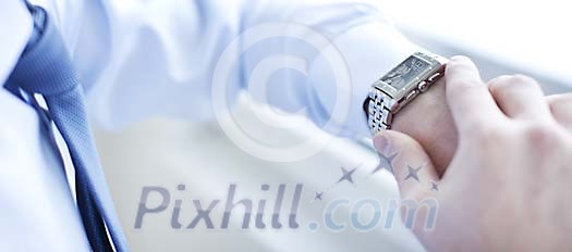 Male looking at his watch Male looking at his watch