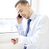 Businessman talking to a phone by the window