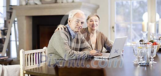 Senior couple using laptop at home Senior couple using laptop at home