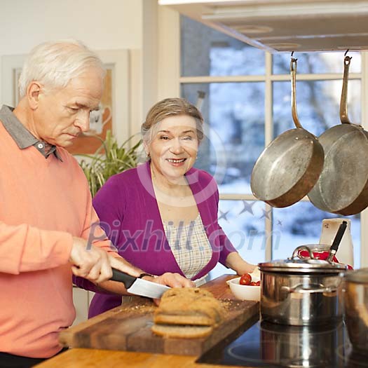 Senior couple cooking together in the kitchen Senior couple cooking together in the kitchen