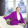 Senior woman sitting on a living room couch