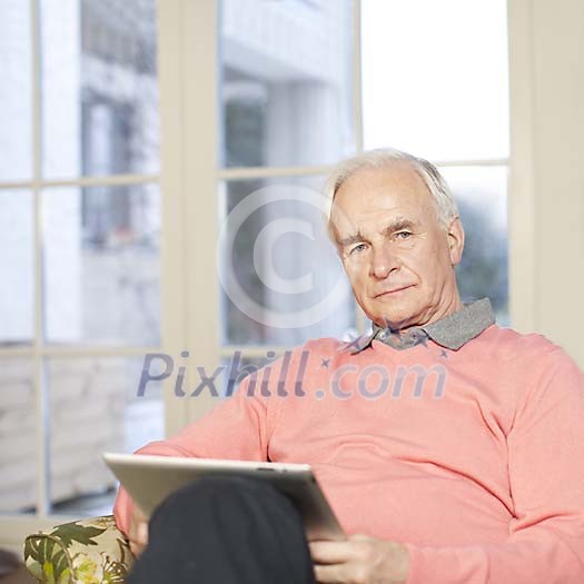 Senior man at home with tablet computer Senior man at home with tablet computer