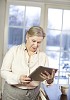 Senior woman with tablet computer at home