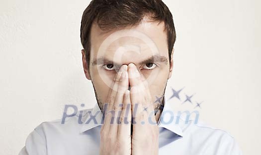 Businessman hiding his face behind his hands Businessman hiding his face behind his hands