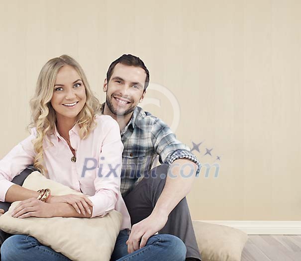 Couple sitting on the floor at home Couple sitting on the floor at home