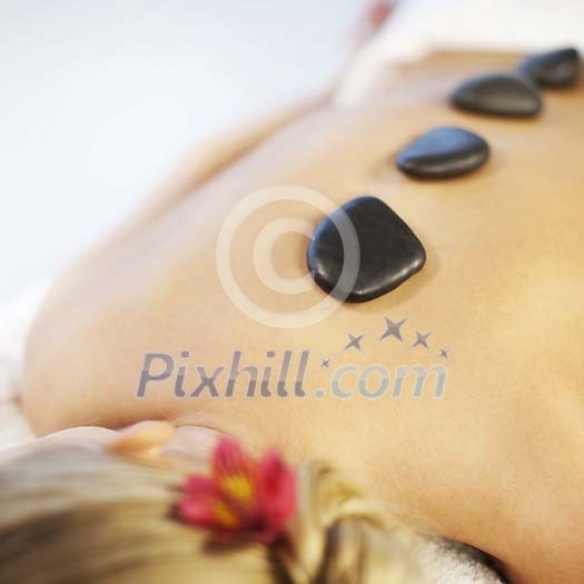 Woman having a lava stone treatment Woman having a lava stone treatment