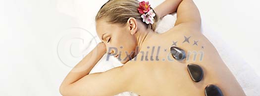 Woman having a lava stone massage Woman having a lava stone massage