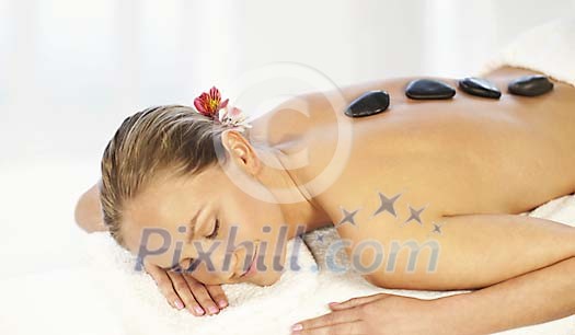 Woman having a lava stone treatment Woman having a lava stone treatment