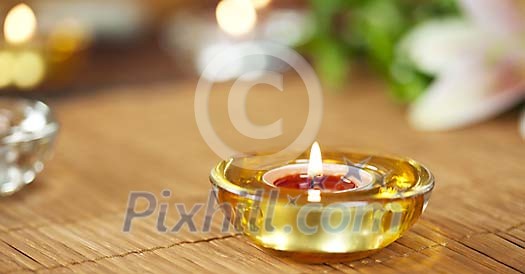 Burning candle on the bamboo rug Burning candle on the bamboo rug
