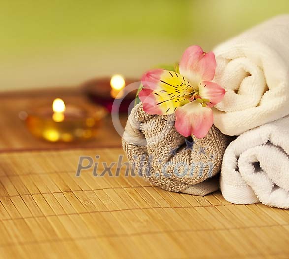 Towels with a flower and candles Towels with a flower and candles