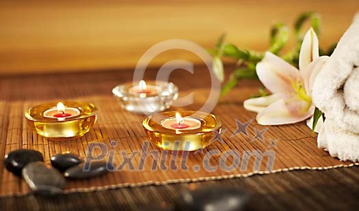 Candles with lava stones and a lily Candles with lava stones and a lily