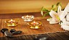 Candles with lava stones and a lily