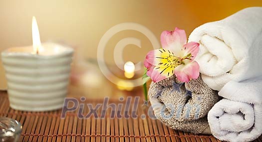 Towels with a folower and a candle Towels with a folower and a candle