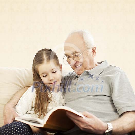 Grandpa reading with his granddaughter Grandpa reading with his granddaughter