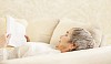 Older female reading on the sofa