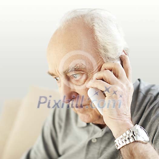Older man talking to a phone Older man talking to a phone