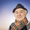 Older man dressed to go outside