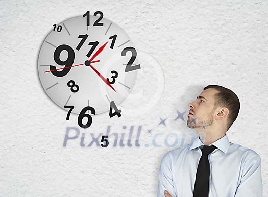 Businessman looking at the wall clock Businessman looking at the wall clock