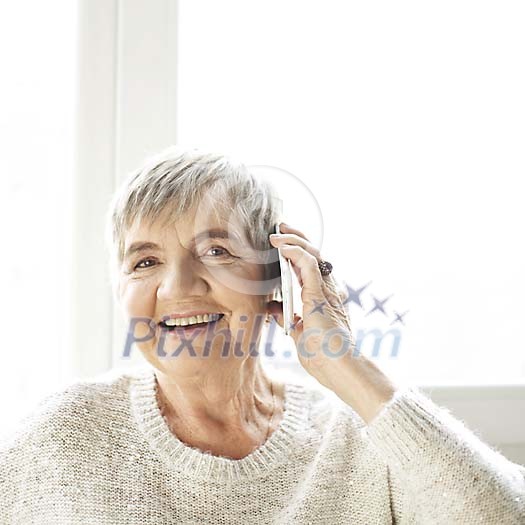 Senior woman talking to a phone Senior woman talking to a phone