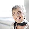 Senior woman smiling by the window