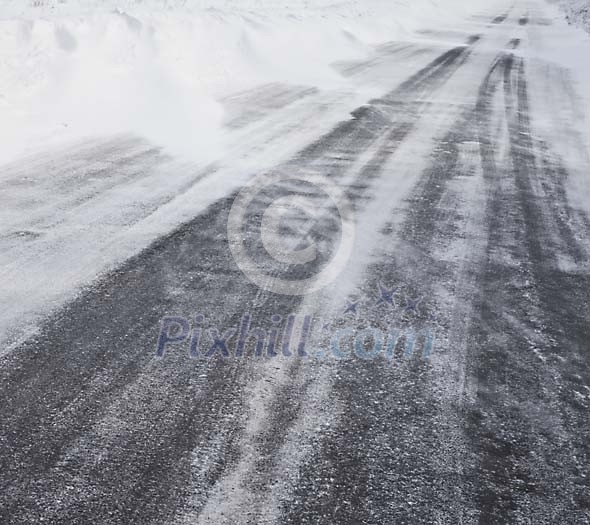 Asphalt covered in snow and ice Asphalt covered in snow and ice