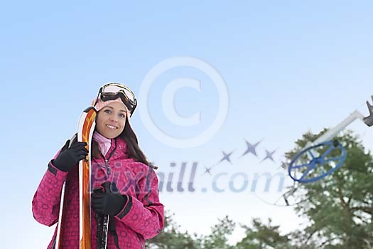 Woman standing with skis outside Woman standing with skis outside