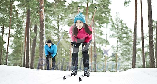 Couple skiing in the forest Couple skiing in the forest