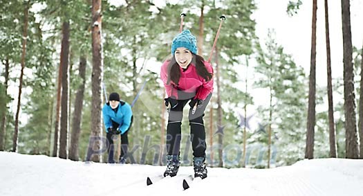 Couple skiing in the forest