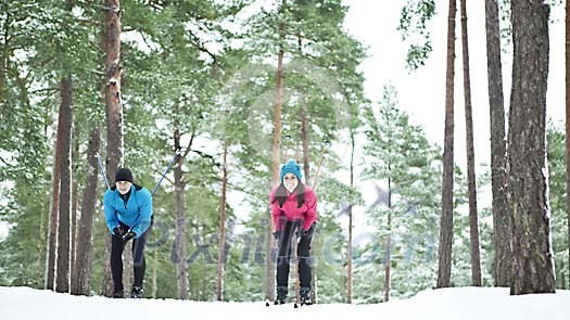 Couple skiing in the forest