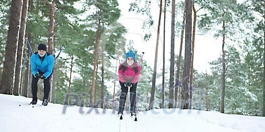 Couple skiing in the forest Couple skiing in the forest