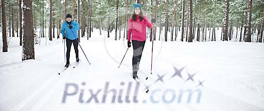 Couple skiing in the forest