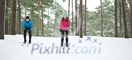 Couple skiing in the forest Couple skiing in the forest