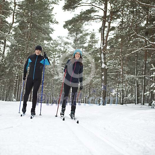 Couple skiing in the forest Couple skiing in the forest
