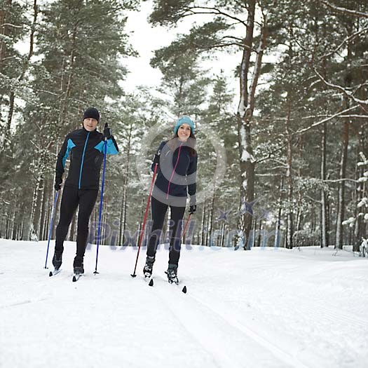 Couple skiing in the forest