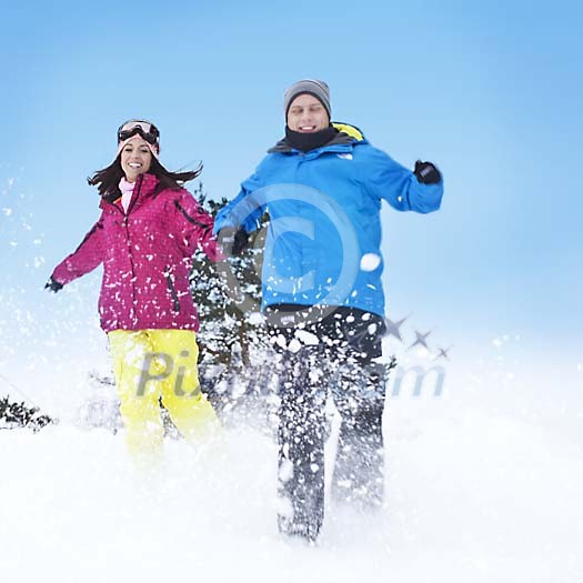Couple running in the snow Couple running in the snow
