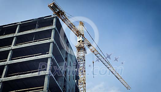 Crane and a house being built Crane and a house being built