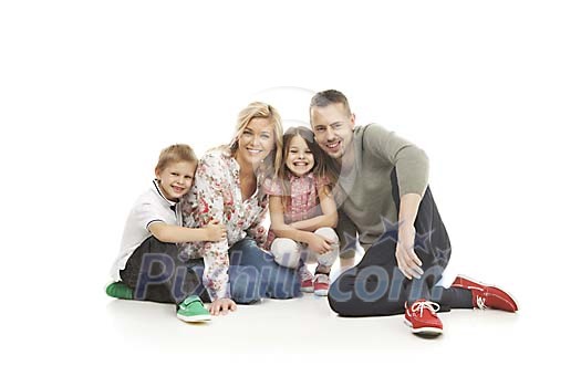 Smiling family sitting on the floor Smiling family sitting on the floor