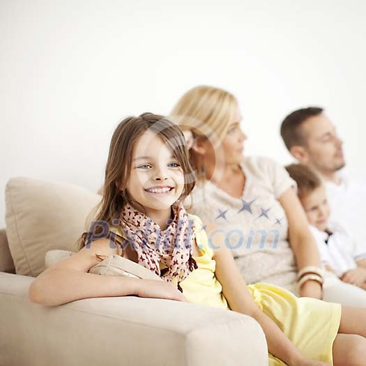 Girl smiling, sitting with family