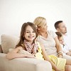 Girl smiling, sitting with family