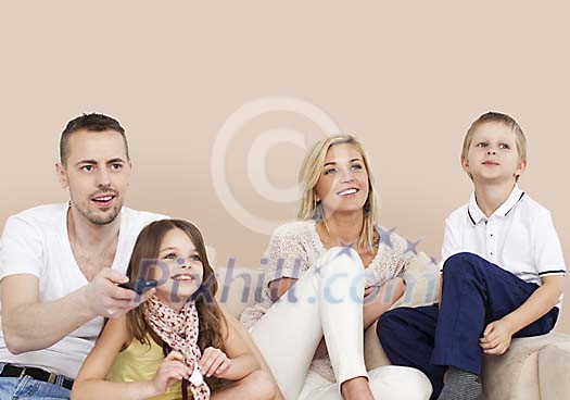 Family watching tv together Family watching tv together