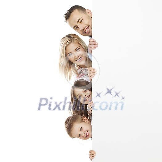 Family peeking behind a white wall Family peeking behind a white wall
