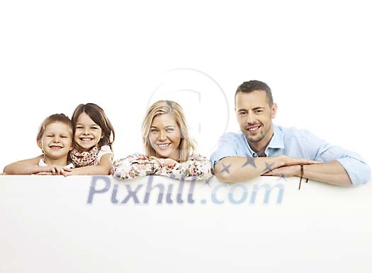 Smiling family behind a poster Smiling family behind a poster