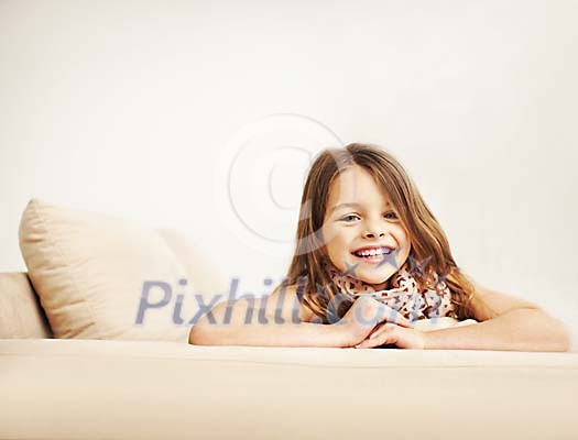 Smiling girl on a sofa Smiling girl on a sofa