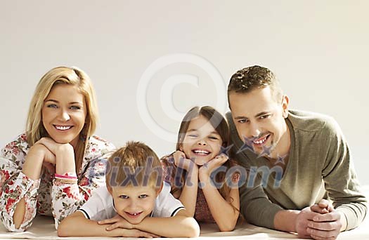 Smiling family on the floor Smiling family on the floor