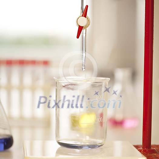 Drop from the pipette falling to a measuring glass Drop from the pipette falling to a measuring glass